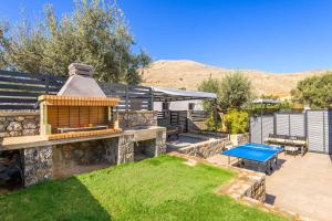 a backyard with a picnic table and a blue ping at Lambis Athina in Lindos