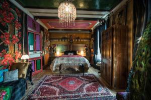 a bedroom with a bed and a chandelier at L Annexe d Aubrac in Aubrac