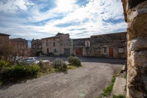 an old stone building with a road in front of it at Gîte Ludomi in Vercheny