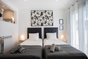 a bedroom with two beds with towels on them at Sea view - dream Nazaré in Nazaré +26 photos