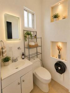 a white bathroom with a toilet and a sink at Loft Maria in Tlazcalancingo +15 photos