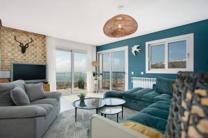a living room with a couch and a table at Sea view - dream Nazaré in Nazaré