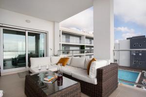 a living room with a couch and a table at Sea view - dream Nazaré in Nazaré