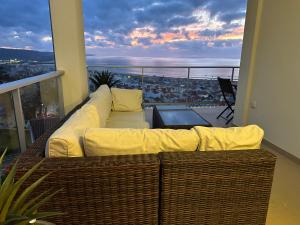 a white couch sitting on a balcony with a view at Sea view - dream Nazaré in Nazaré