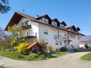 a large white house with a roof at Bergchalet Mirabell - Hofgut in Friedrichshafen