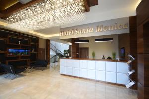 a hotel lobby with a hotel santa monica sign at Hotel Santa Monica in Mikołajki