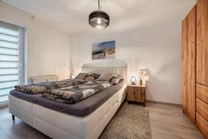 a bedroom with a large bed in a room at Fewo Seehase in Dorum-Neufeld
