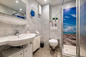 a bathroom with a sink and a toilet and a shower at Fewo Seehase in Dorum-Neufeld +19 photos