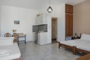 a living room with two beds and a kitchen at Frantzis studio 1 in Páloi