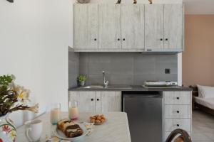 a kitchen with a table with a plate of food on it at Frantzis studio 1 in Páloi +20 photos