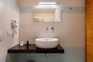 a bathroom with a sink and a mirror at Dolomitc Tobià in Campitello di Fassa +15 photos