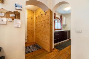 a hallway with a wooden door in a house at Dolomitc Tobià in Campitello di Fassa