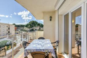 a table on a balcony with a view of the city at Escala Riells in L'Escala