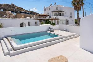 a swimming pool on the roof of a house at Irene's Studio in Mikonos