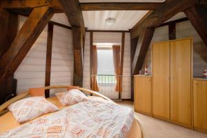 a bedroom with a bed in a room with wooden ceilings at Fewo Nordermühle in Pellworm