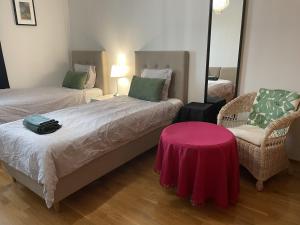 a room with two beds and a table and a chair at Helsinki Green Retreat in Helsinki