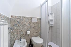 a small bathroom with a toilet and a sink at Casa vacanza Sotto La Lizza in Alezio +20 photos