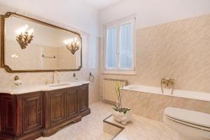 a bathroom with a tub and a sink and a mirror at Miriam e Carlo in Moneglia +14 photos