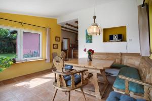 a dining room with a wooden table and chairs at Fereienhaus Usedom Achterland in Dewichow