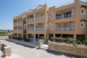 a large apartment building with balconies and plants at Sunrise Apartments Crete in Sfakaki