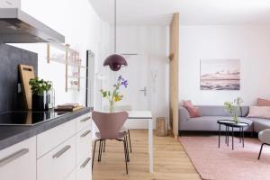 a kitchen and living room with a table and a couch at Koje in Böhl