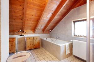 a bathroom with a tub and a toilet and a sink at Ferienhaus Sankt Peter in Wittenschwand +27 photos