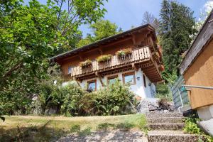 a house with a balcony with flowers on it at Ferienhaus Sankt Peter in Wittenschwand
