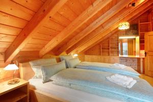 a bedroom with a bed in a wooden attic at Ferienhaus Sankt Peter in Wittenschwand