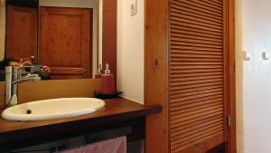 a bathroom with a sink and a person taking a picture in the mirror at La Clé des Sens in Castelnau-Pégayrols +16 photos