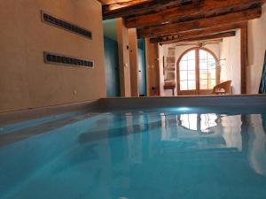a large swimming pool in a house with at La Clé des Sens in Castelnau-Pégayrols