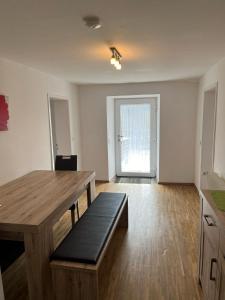 an empty living room with a table and a bench at Ferienhof Rohrbachhof in Schiltach