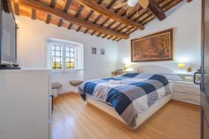 a bedroom with a bed and a tv in a room at Can Tarana in Santa Cristina d'Aro +24 photos
