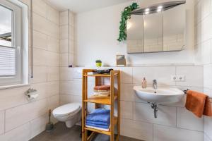 a bathroom with a sink and a toilet at Ferienwohnung "Haus Kellenburg" in Albstadt +44 photos