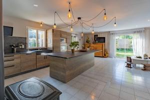a large kitchen with a large island in the middle at Petit coin de paradis Périgourdin in Montrem