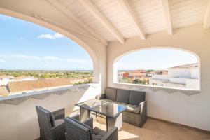 a balcony with a table and chairs and a view at Attico con vista mare a Budoni in Budoni