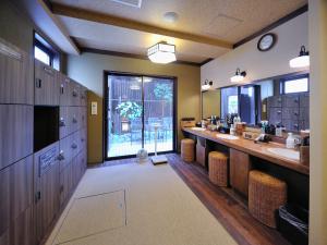 a large bathroom with two sinks and a large window at Dormy Inn Akihabara in Tokyo