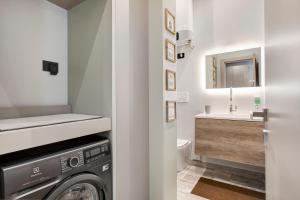 a bathroom with a washing machine and a sink at Maison Bijoux Aosta in Aosta +25 photos