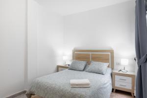 a bedroom with a bed with a towel on it at Piso Leoncio Breña Alta in Breña Alta