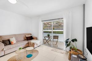 a living room with a couch and a table at Bajamar en armonía in Bajamar