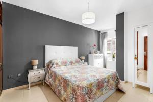 a bedroom with a bed and a wall at Bajamar en armonía in Bajamar +23 photos