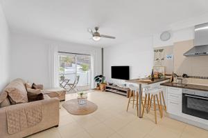 a kitchen and living room with a couch and a table at Bajamar en armonía in Bajamar