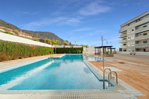 a swimming pool in the middle of a building at Bajamar en armonía in Bajamar