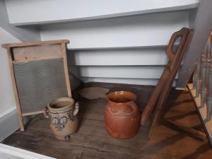 two vases sitting on a wooden floor next to a staircase at Ferienwohnung Zur Eisenbahn in Fladungen