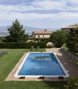a large swimming pool in the yard of a house at Masoveria De Vilanova in Sagás