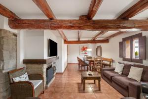 a living room with a couch and a fireplace at Masoveria De Vilanova in Sagás