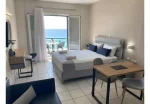 a bedroom with a bed and a view of the ocean at Sunset Premium Studio 13 in Lefkada