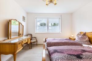 a bedroom with a bed and a dresser and a mirror at Ferienwohnung "Haus Kellenburg" in Albstadt