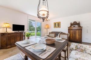 a dining room with a table and a tv at Ferienwohnung "Haus Kellenburg" in Albstadt