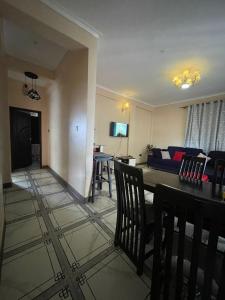 a living room with a table and a couch at Alz Haven in Jinja