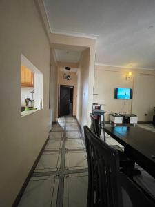 a hallway with a table and chairs in a room at Alz Haven in Jinja